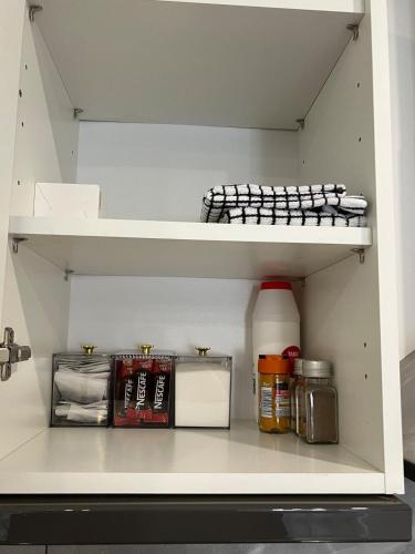 a shelf in a refrigerator filled with food at Guest house in london in Edgware