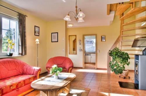 ein Wohnzimmer mit zwei roten Sofas und einem Tisch in der Unterkunft Krabbenort 1 - 6b in Prerow
