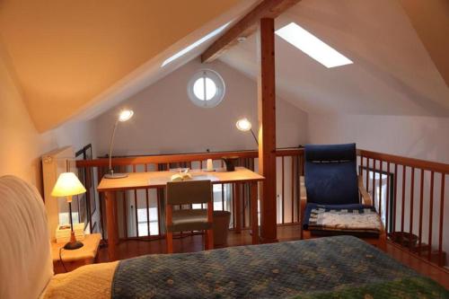 a bedroom with a bed and a table and a chair at Ferienwohnung Döbbelin in Prerow