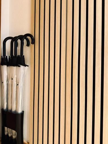a group of umbrellas hanging on a wall at VALEMI BohoChic I 2BR 6PAX I TopLage I Parkplatz I Balkon I Küche in Landsberg am Lech