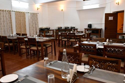 a dining room with wooden tables and chairs at Ranthambhore Tiger Territory in Sawāi Mādhopur
