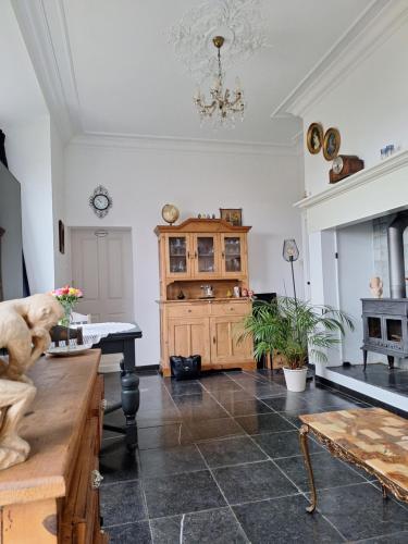 a living room with a table and a chandelier at Polderzicht in Ossendrecht