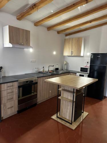 une cuisine avec un îlot en bois au milieu dans l'établissement Appartement 2 chambres, à Baix