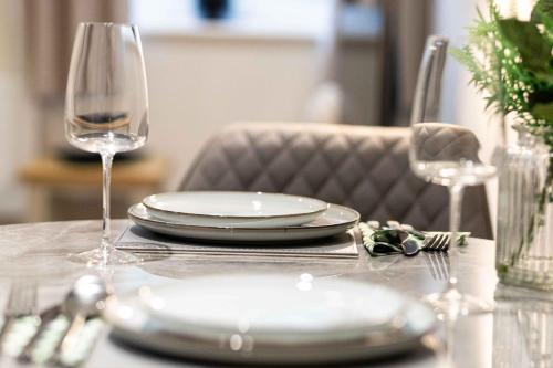 a table with plates and glasses on top of it at Rock Mill 1 Bed Apartment 37 in Stoney Middleton