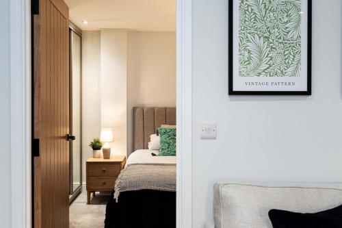 a bedroom with a bed and a picture on the wall at Rock Mill 1 Bed Apartment 37 in Stoney Middleton