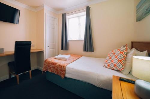 a hotel room with a bed and a window at Rooms At 95 Long Street in Atherstone