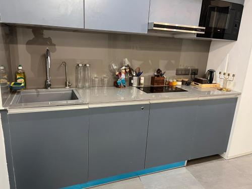 a kitchen with a sink and a counter top at Sukoon by Urban Retreat in New Delhi