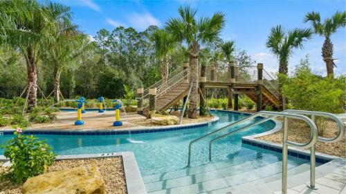 a pool at a resort with a slide at 5BR w/Private Pool | Luxury at Storey Lake in Kissimmee
