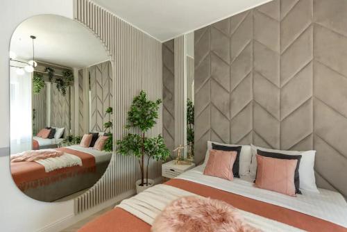 a bedroom with two beds and a large mirror at AIASTAY Bucharest River Apartments in Bucharest