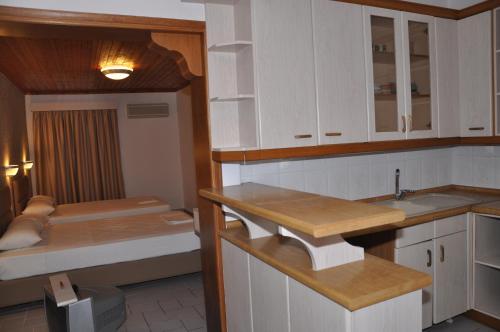 una cucina con armadietti bianchi e un letto a castello di Villa Nikolas a Paralia Katerinis