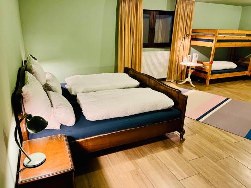 a room with two beds and a desk with a lamp at Gemütliche Unterkunft Flughafen Köln-Bonn CGN in Cologne