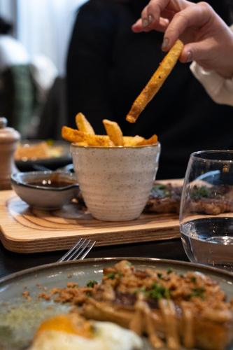 a person is holding a bowl of french fries at FirstName Bordeaux, Part of JdV by Hyatt in Bordeaux