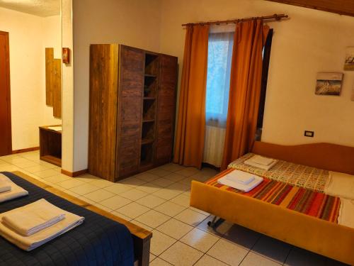 a hotel room with two beds and a shower at Agriturismo Scuderia Castello in Gaino