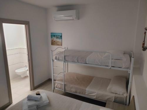 a room with two bunk beds and a bathroom at Al Mare da Francesca in Olbia