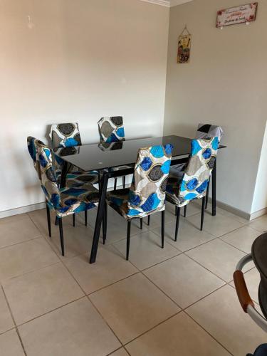 a black dining room table and chairs with blue at Depto completo hasta 5 personas in Los Andes