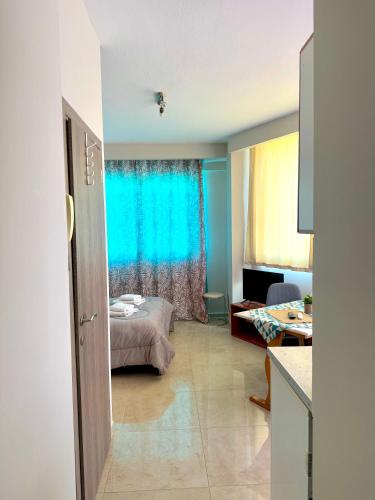 a room with a bed and a blue curtain at Alpha apartments 35 in Serres