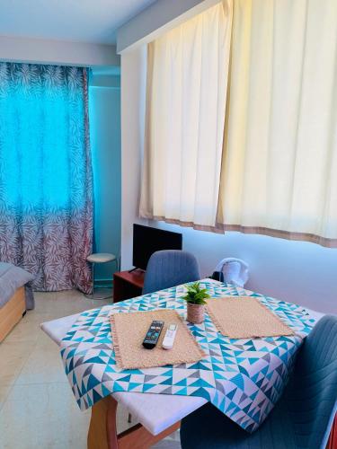 a room with a table with two controllers on it at Alpha apartments 35 in Serres