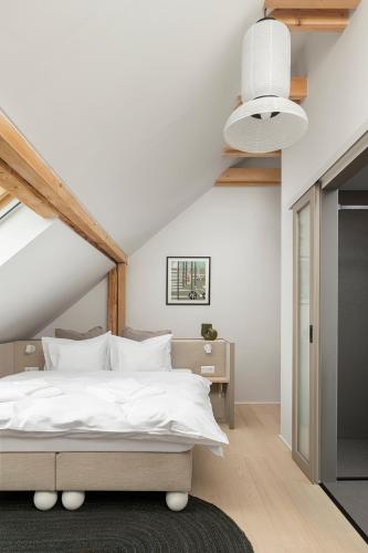 a bedroom with a white bed and a white ceiling at Buborék in Csopak