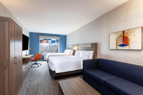 a hotel room with a bed and a couch at Holiday Inn Express and Suites Missoula by IHG in Missoula