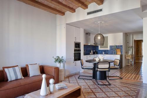 a living room with a couch and a table at Factory Apartments Barcelona in Barcelona