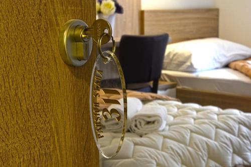 a door with a mirror next to a bed at Hotel Stana in Međugorje
