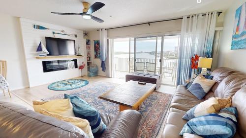 a living room with a couch and a table at Amazing views & steps to beach 2B-2Bath-Pool 333 in Clearwater Beach