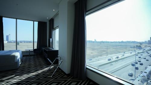 a room with a large window with a view of an airport at Mirada Blue Falestine - Serviced Apartments in Jeddah
