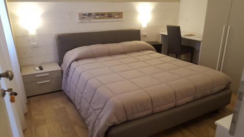 a bedroom with a bed and a desk and a table at Casa Mafalda in Chioggia