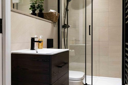 a bathroom with a sink and a shower at Rock Mill Duplex Apartment 42 in Stoney Middleton