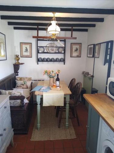 a living room with a table and a couch at 7 Front Street in Saint Johns Chapel