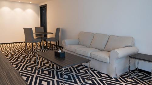 a living room with a couch and a table at Mirada Blue Falestine - Serviced Apartments in Jeddah