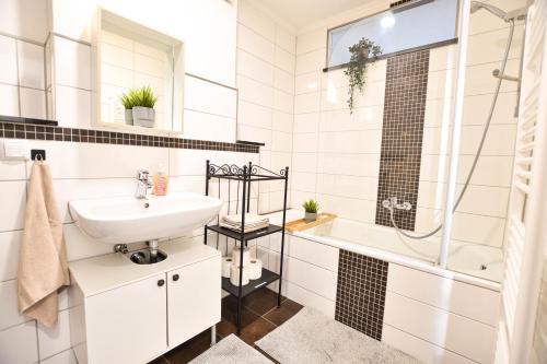 a white bathroom with a sink and a shower at Ferienwohnung Karl in Dessau