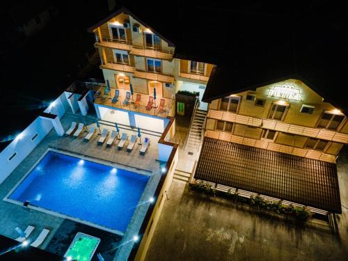 an overhead view of a building with a swimming pool at Pensiunea Petra- Clisura Dunarii in Divici