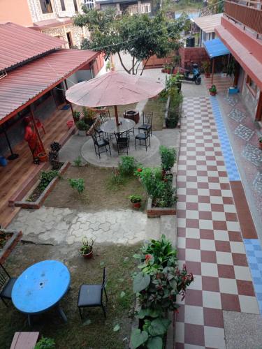 an overhead view of a patio with a table and umbrella at Pokhara Metro Eco Hotel in Pokhara