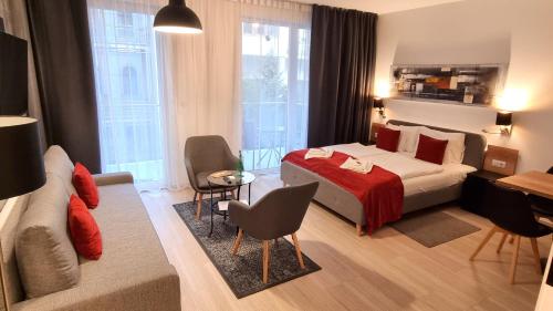 a hotel room with a bed and a couch at B40 Green ApartRooms in Budapest