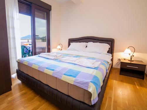 a bedroom with a bed with a view of the ocean at Bel&Rus Sea Apartment in Budva