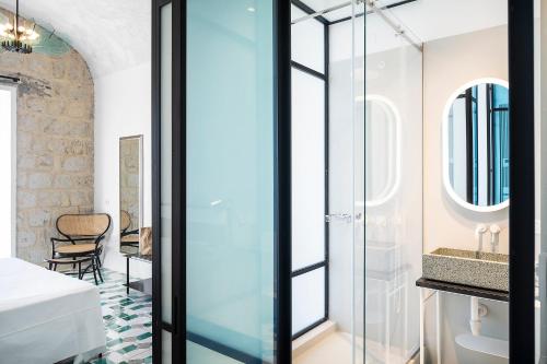 a bathroom with a glass shower and a sink at Miramare Sea Resort & Spa in Ischia