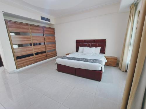 a bedroom with a large bed in a room at Marina Tower in Juffair