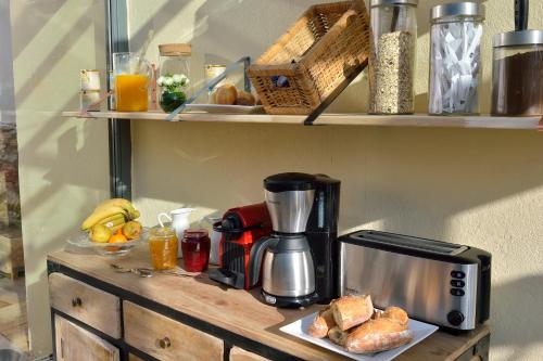 a coffee maker on a counter with a plate of food at B&B Villa Du Roc Fleuri in Cannes