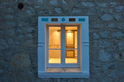 a window in a stone wall with a light inside at B&B Villa Du Roc Fleuri in Cannes