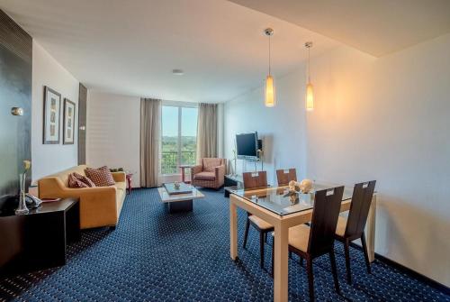 a living room with a couch and a table at Hodelpa Garden Court in Santiago de los Caballeros