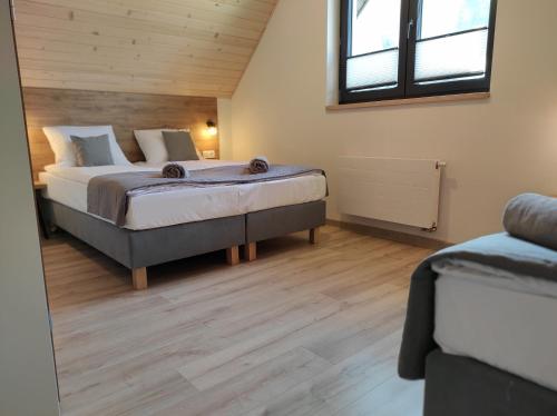 a bedroom with a large bed in a room at Domki Pienińskie in Szczawnica