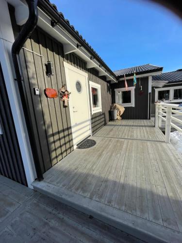 a front door of a house with a wooden deck at Henar Bed & Breakfast in Gävle