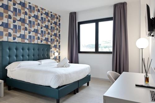 Postel nebo postele na pokoji v ubytování Hotel HE ROMA