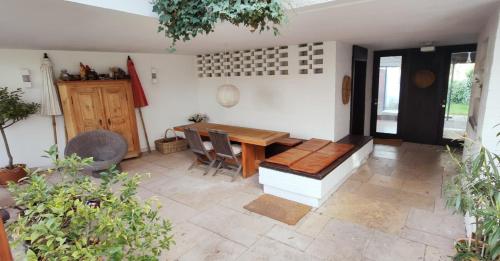 a dining room with a wooden table and chairs at Architektenhaus - Architect's House in Ebersberg