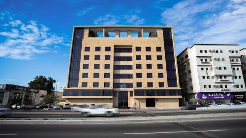 a building on a street with cars in front of it at Mirada Blue Falestine - Serviced Apartments in Jeddah