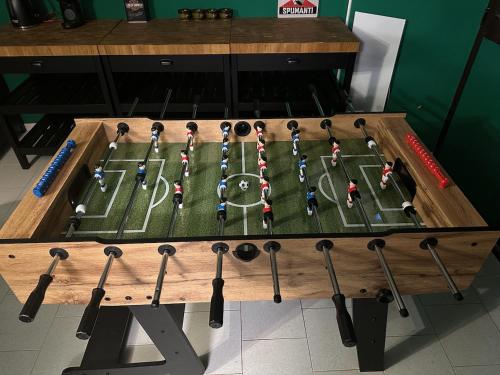a table with a football field with baseball bats at Villa Eugenia in Košljun