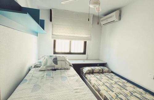 a small room with a bed and a window at Casa La Higuera in Retamar