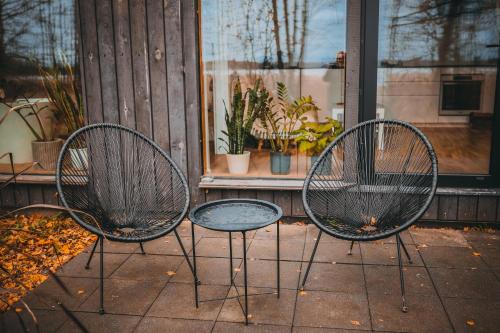 two chairs and a table in front of a window at Ezernams SPA in Kaukuri