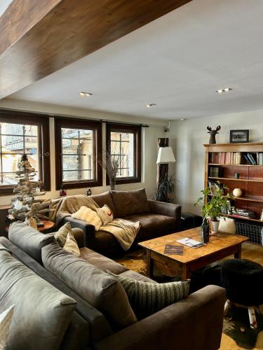 a living room with couches and a coffee table at Au Vieux Moulin in Megève